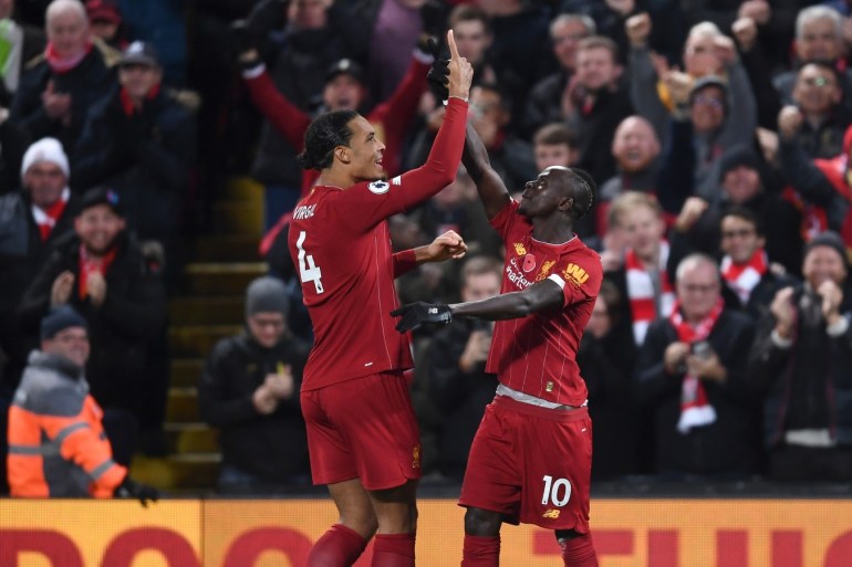 LIVERPOOL, ENGLAND - NOVEMBER 10: Sadio Mane of Liverpool celebrates after scoring his team's third goal with teammate Virgil van Dijk during the Premier League match between Liverpool FC and Manchester City at Anfield on November 10, 2019 in Liverpool, United Kingdom. (Photo by Laurence Griffiths/Getty Images)