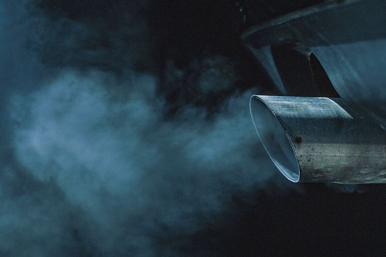 a exhaust pipe of a car emitting fumes