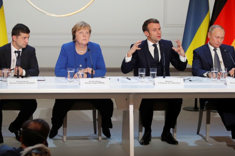 Ukraine's President Volodymyr Zelenskiy, German Chancellor Angela Merkel, French President Emmanuel Macron and Russia's President Vladimir Putin attend a joint news conference after a Normandy-format summit in Paris, France, December 9, 2019. REUTERS/Charles Platiau/Pool?
