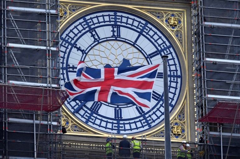A Union Jack flag flutters in front of Big Ben as workers inspect one of its clocks, in London, Britain September 11, 2019. REUTERS/Toby Melville