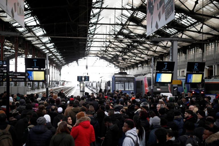 Commuters of French national railway operator SNCF wait on a platform at Gare de Lyon train station as a strike by French SNCF railway and Paris transport network (RATP) workers continues against French government's pensions reform plans, in Paris, France, December 8, 2019. REUTERS/Benoit Tessier