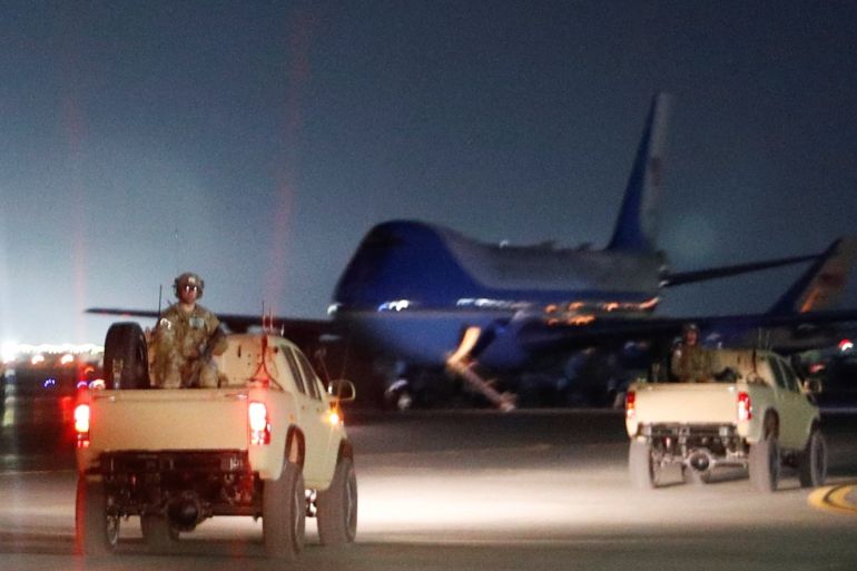 Armed U.S. troops travel inside the presidential motorcade ahead of Air Force One, at the tarmac at Bagram Air Field during a surprise visit by U.S. President Donald Trump at Bagram Air Base in Afghanistan, November 28, 2019. REUTERS/Tom Brenner