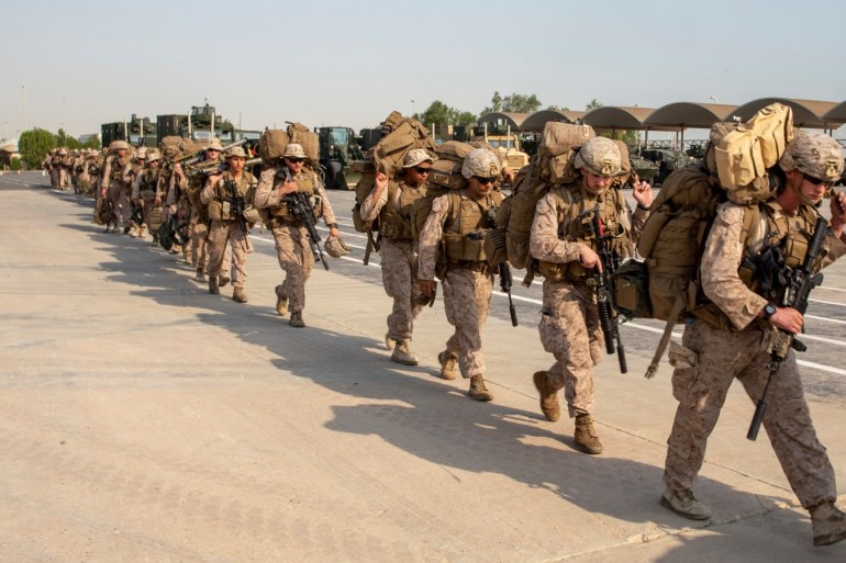 Marines with Lima Company, Battalion Landing Team 3/5, 11th Marine Expeditionary Unit (MEU) prepare to load gear onto a landing craft, air cushion at Kuwait Naval Base, Kuwait City, Kuwait, in this undated handout picture released by U.S. Navy on August 7, 2019. Jared Sabins/U.S. Army/Handout via REUTERS ATTENTION EDITORS- THIS IMAGE HAS BEEN SUPPLIED BY A THIRD PARTY.