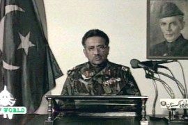 Pakistani army chief General Pervez Musharraf speaks on state television in front of a picture of the founder of Pakistan, Mohammed Ali Jinnah, October 13. Pakistan [Prime Minister Nawaz Sharif] was toppled in a military coup on Tuesday, and Musharraf said the army moved in to save a deteriorating situation.**POOR TV QUALITY DOCUMENT**