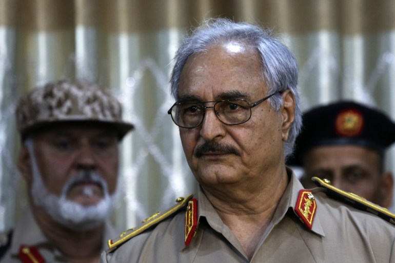 General Khalifa Haftar speaks during a news conference at a sports club in Abyar, a small town to the east of Benghazi May 21, 2014. Haftar called on the government to hand over power to the country's top judges, mounting a challenge against Tripoli as heavy fighting erupted in the capital on Wednesday. Western powers fear a call by Haftar for army units to join his campaign will split the nascent military and trigger more turmoil in the oil producing country which is struggling to restore order three years after the fall of strongman Muammar Gaddafi. REUTERS/Esam Omran Al-Fetori (LIBYA - Tags: CIVIL UNREST POLITICS MILITARY)
