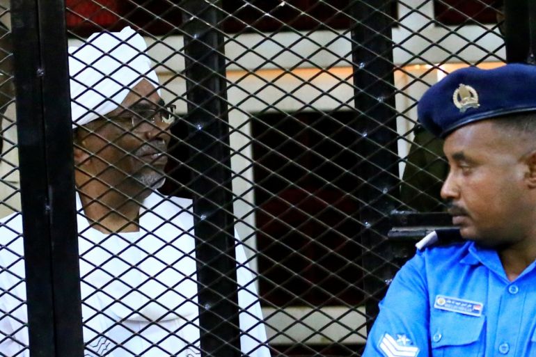 Sudan's former president Omar Hassan al-Bashir sits inside a cage during the hearing of the verdict that convicted him of corruption charges in a court in Khartoum, Sudan, December 14, 2019. REUTERS/Mohamed Nureldin Abdallah