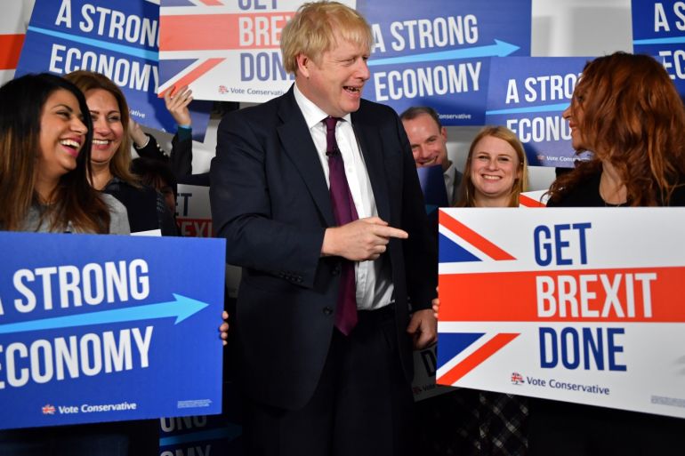 Britain's Prime Minister Boris Johnson speaks to activists and supporters as he poses for a photograph at the Conservative Campaign Headquarters Call Centre in central London, Britain, December 8, 2019. Ben Stansall/Pool via REUTERS
