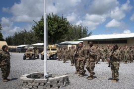 epa08104085 A handout photo made available by US Air Force on 05 January 2020, showing US Air Force Airmen from the 475th Expeditionary Air Base Squadron conducting a flag-raising ceremony at Camp Simba in Lamu, Kenya, 26 August 2019. The 475th EABS raised the flag for the first time since the base operating support-integrator mission started in 2017, signifying the change from tactical to enduring operations. Reports on 05 January 2020 state suspected Al Shabaab militi