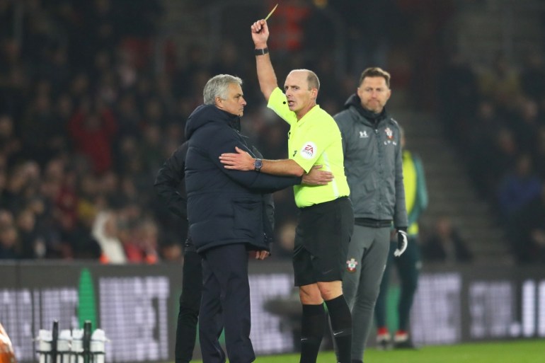 SOUTHAMPTON, ENGLAND - JANUARY 01: Match Referee Mike Dean shows a yellow card to Jose Mourinho, Manager of Tottenham Hotspur during the Premier League match between Southampton FC and Tottenham Hotspur at St Mary's Stadium on January 01, 2020 in Southampton, United Kingdom. (Photo by Michael Steele/Getty Images)