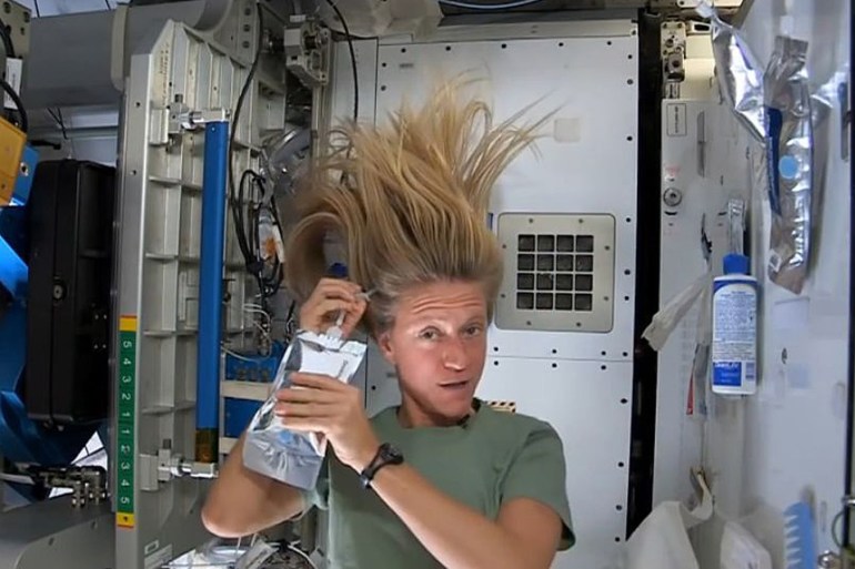 NASA astronaut Karen Nyberg, currently serving as part of Expedition 36 aboard the International Space Station, demonstrates how she washes her hair in zero gravity in this still image taken from NASA video released July 12, 2013. REUTERS/NASA/Handout via Reuters (OUTER SPACE - Tags: SCIENCE TECHNOLOGY SOCIETY) ATTENTION EDITORS - THIS IMAGE WAS PROVIDED BY A THIRD PARTY. FOR EDITORIAL USE ONLY. NOT FOR SALE FOR MARKETING OR ADVERTISING CAMPAIGNS. THIS PICTURE IS DISTRIBUTED EXACTLY AS RECEIVED BY REUTERS, AS A SERVICE TO CLIENTS