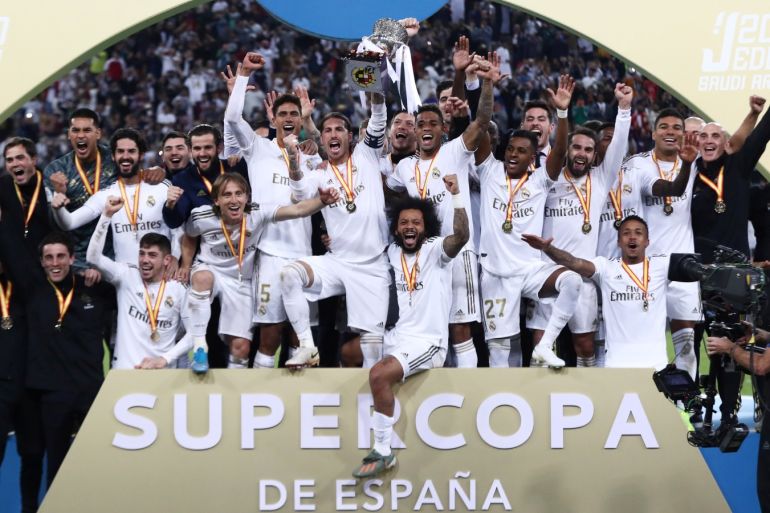 Soccer Football - Spanish Super Cup Final - Real Madrid v Atletico Madrid - King Abdullah Sports City, Jeddah, Saudi Arabia - January 12, 2020 Real Madrid players lift the trophy as they celebrate winning the Super Cup REUTERS/Sergio Perez