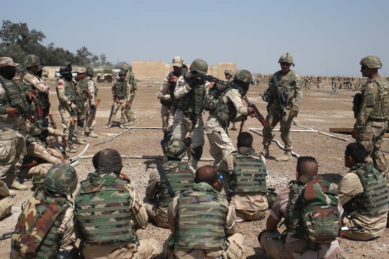 TAJI, IRAQ - APRIL 12: U.S. Army trainers instruct as Iraqi Army recruits at a military base on April 12, 2015 in Taji, Iraq. Members of the U.S. Army's 5-73 CAV, 3BCT, 82nd Airborne Division are teaching soldiers from the newly-formed 15th Division of the Iraqi Army, as the Iraqi government launches offensives to try to recover territory lost to ISIS last year. U.S. forces, currently operating in 5 large bases throught Iraq, are training thousands of Iraqi Army combat troops, trying to rebuild a force they had origninally trained before the U.S. withdrawal from Iraq in 2010. (Photo by John Moore/Getty Images)