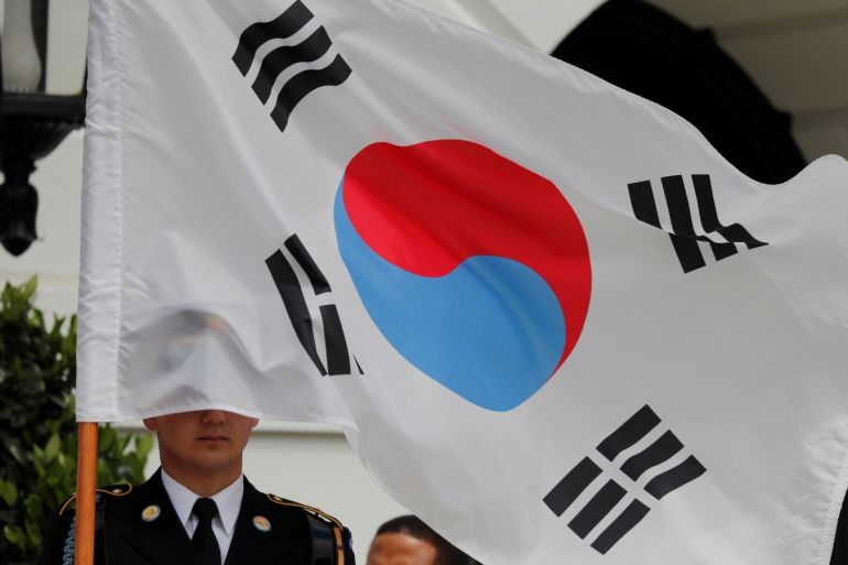 A South Korean flag covers a ceremonial guard member prior to the arrival of South Korea’s President Moon Jae-in at the White House in Washington, U.S., April 11, 2019. REUTERS/Carlos Barria