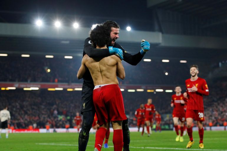 Soccer Football - Premier League - Liverpool v Manchester United - Anfield, Liverpool, Britain - January 19, 2020 Liverpool's Mohamed Salah celebrates scoring their second goal with Alisson REUTERS/Phil Noble EDITORIAL USE ONLY. No use with unauthorized audio, video, data, fixture lists, club/league logos or