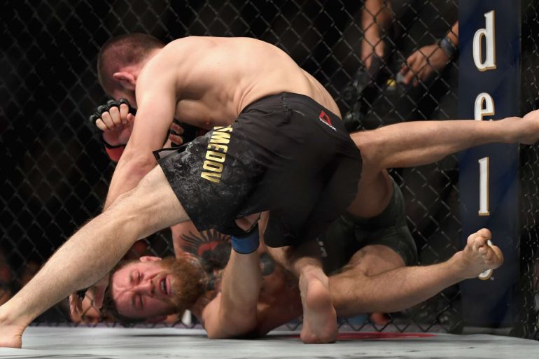 LAS VEGAS, NV - OCTOBER 06: Khabib Nurmagomedov of Russia (top) punches Conor McGregor of Ireland in their UFC lightweight championship bout during the UFC 229 event inside T-Mobile Arena on October 6, 2018 in Las Vegas, Nevada. Harry How/Getty Images/AFP== FOR NEWSPAPERS, INTERNET, TELCOS & TELEVISION USE ONLY ==