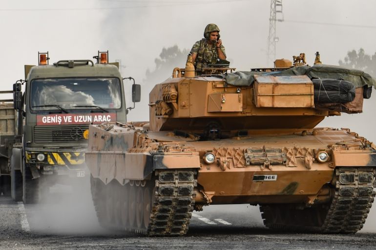 CEYLANPINAR, TURKEY - OCTOBER 18: A Turkish army tank moves towards the Syrian border on October 18, 2019 in Ceylanpinar, Turkey. Turkish forces appeared to continue shelling targets in Northern Syria despite yesterday's announcement, by U.S. Vice President Mike Pence, that Turkey had agreed to a ceasefire in its assault on Kurdish-held towns near its border. (Photo by Burak Kara/Getty Images)