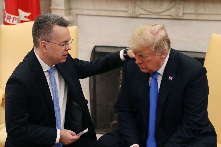WASHINGTON, DC - OCTOBER 13: U.S. President Donald Trump and American evangelical Christian preacher Andrew Brunson (L) participate in a prayer a day after he was released from a Turkish jail, in the Oval Office, on October 13, 2018 in Washington, DC. Brunson was detained for two years in Turkey on espionage and terrorism-related charges that the pastor said were false. Mark Wilson/Getty Images/AFP== FOR NEWSPAPERS, INTERNET, TELCOS & TELEVISION USE ONLY ==