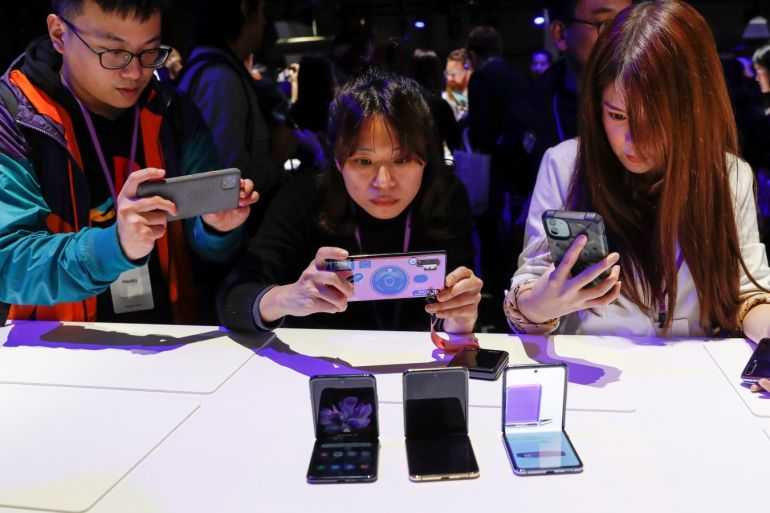 Attendees take photographs of the new Samsung Galaxy Z Flip foldable smartphone during Samsung Galaxy Unpacked 2020 in San Francisco, California, U.S. February 11, 2020. REUTERS/Stephen Lam
