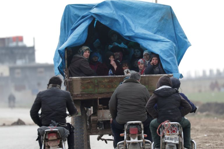 Internally displaced people, who fled from Idlib, ride on a pick up truck with their belongings in Azaz, Syria February 15, 2020. REUTERS/Khalil Ashawi