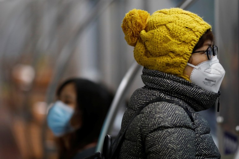 Women wearing face masks ride a subway in the morning after the extended Lunar New Year holiday caused by the novel coronavirus outbreak, in Beijing, China February 10, 2020. REUTERS/Carlos Garcia Rawlins