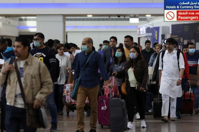 Travellers wear masks as they arrivw at the Dubai International Airport, after the UAE's Ministry of Health and Community Prevention confirmed the country's first case of coronavirus, in Dubai, United Arab Emirates January 29, 2020. REUTERS/Christopher Pike