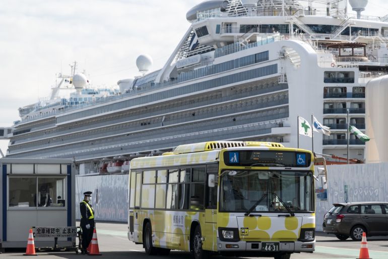 YOKOHAMA, JAPAN - FEBRUARY 19: A bus carrying passengers who disembarked the quarantined Diamond Princess cruise ship drives past the cruise ship at Daikoku Pier on February 19, 2020 in Yokohama, Japan. About 500 passengers who have tested negative for the coronavirus (COVID-19) were allowed to disembark the cruise ship on Wednesday after 14 days quarantine period as at least 542 passengers and crew onboard have tested positive for the coronavirus. Including cases onboard the ship, 615 people in Japan have now been diagnosed with COVID-19 making it the worst affected country outside of China. (Photo by Tomohiro Ohsumi/Getty Images)
