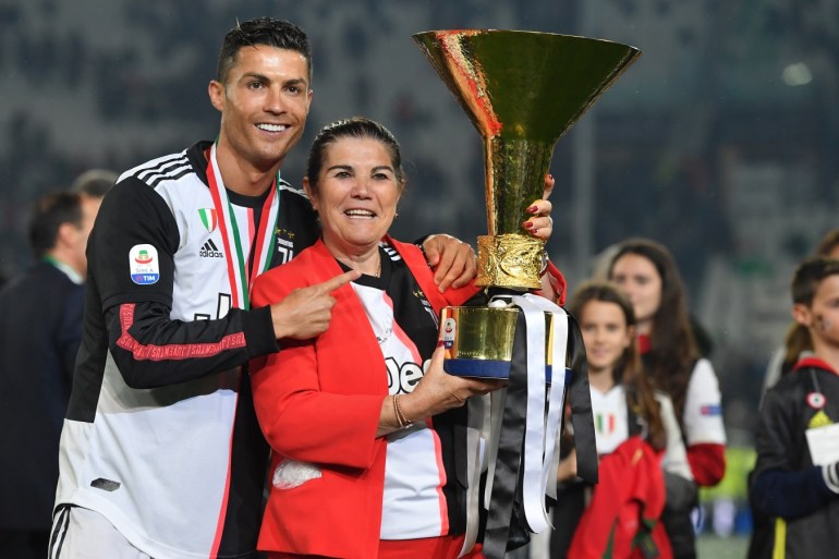TURIN, ITALY - MAY 19: Cristiano Ronaldo (L) of Juventus celebrates with his mother Maria Dolores Aveiro during the awards ceremony after winning the Serie A Championship during the Serie A match between Juventus and Atalanta BC on May 19, 2019 in Turin, Italy. (Photo by Tullio M. Puglia/Getty Images)