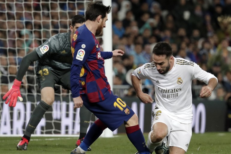 Real Madrid vs Barcelona - La Liga- - MADRID, SPAIN - MARCH 1: Dani Carvajal of Real Madrid in action against Lionel Messi of Barcelona during the Spanish League football match between Real Madrid and Barcelona at the Santiago Bernabeu stadium in Madrid on March 1, 2020.