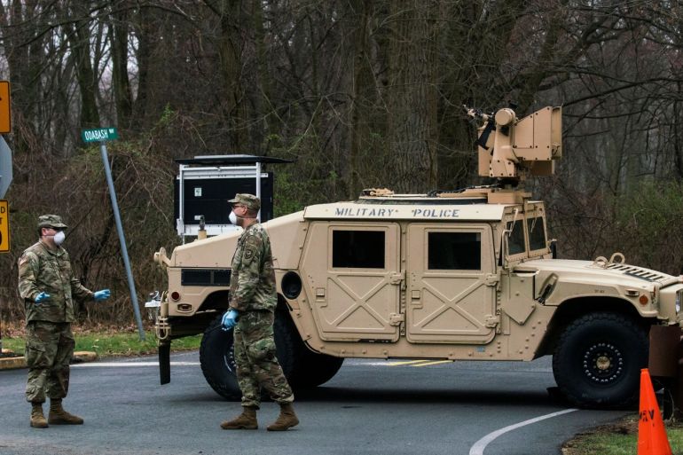 U.S. army soldiers stand guard near the new drive-thru coronavirus disease (COVID-19) testing center at Bergen Community College in Paramus, New Jersey, U.S., March 20, 2020. REUTERS/Eduardo Munoz