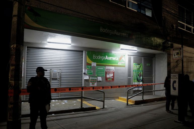 A police officer stands guard outside a looted supermarket express as the spread of coronavirus disease (COVID-19) continues in Mexico City, Mexico March 25, 2020. REUTERS/Luis Cortes
