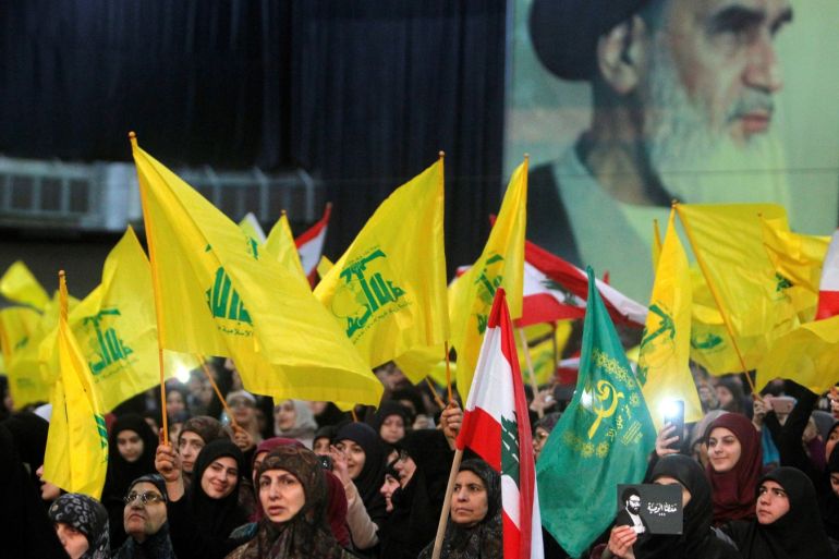 Female supporters of Lebanon's Hezbollah hold flags listening to their leader Sayyed Hassan Nasrallah as he speaks on a video screen in Beirut, Lebanon February 16, 2018. REUTERS/Aziz Taher