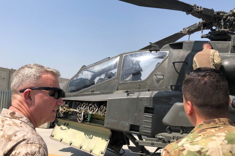 Marine General Kenneth McKenzie, head of U.S. Central Command, speaks with a U.S. soldier as they stand in front of a U.S. attack helicopter during a visit to Forward Operating Base Fenty in Jalalabad, Afghanistan, September 9, 2019. REUTERS/Phil Stewart