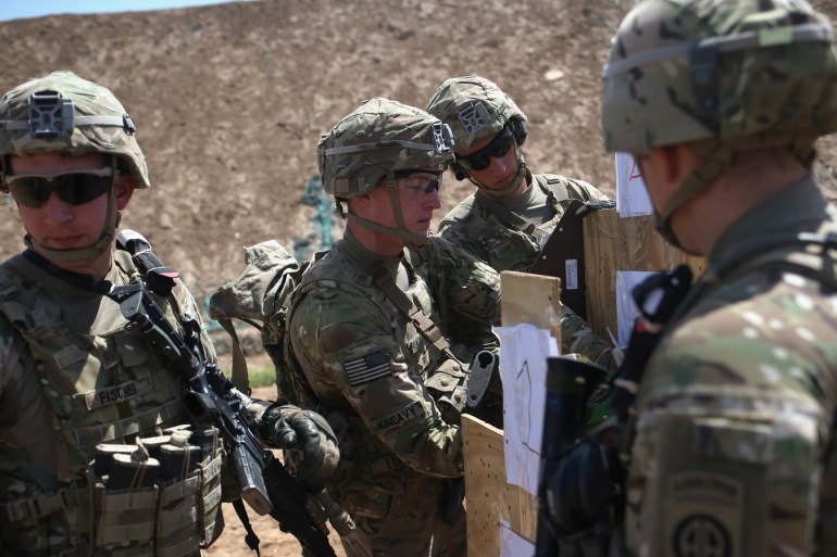 TAJI, IRAQ - APRIL 12: U.S. Army trainers set up targets at a military base on April 12, 2015 in Taji, Iraq. Members of the U.S. Army's 5-73 CAV, 3BCT, 82nd Airborne Division are teaching members of the newly-formed 15th Division of the Iraqi Army, as the Iraqi government launches offensives to try to recover territory lost to ISIS last year. U.S. forces, currently operating in 5 large bases throught the country, are training thousands of Iraqi Army combat troops, trying to rebuild a force they had origninally trained before the U.S. withdrawal from Iraq in 2010. (Photo by John Moore/Getty Images)