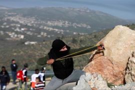 A Palestinians protest illegal Israeli settlements near the town of Beita