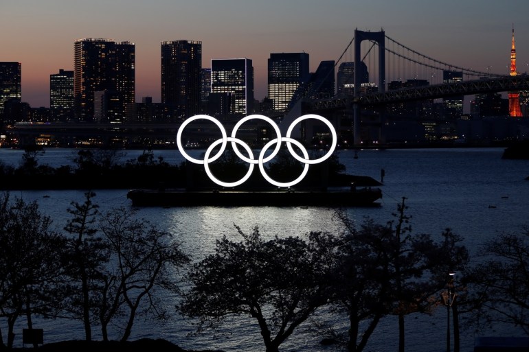 The giant Olympic rings are seen through at the waterfront area at Odaiba Marine Park after postponing Games due to the outbreak of coronavirus disease (COVID 19), in Tokyo, Japan March 25, 2020. REUTERS/Issei Kato