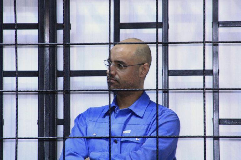Saif al-Islam Gaddafi, son of late Libyan leader Muammar Gaddafi, attends a hearing behind bars in a courtroom in Zintan May 15, 2014. REUTERS/Stringer (LIBYA - Tags: POLITICS CIVIL UNREST)