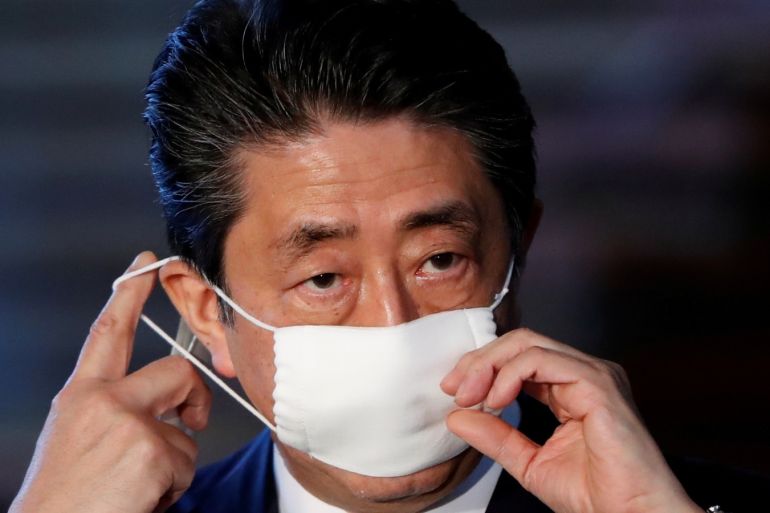 Japan's Prime Minister Shinzo Abe adjusts his face mask as he arrives to speak to the media on Japan's response to the coronavirus disease (COVID-19) outbreak, at his official residence in Tokyo, Japan, April 6, 2020. REUTERS/Issei Kato