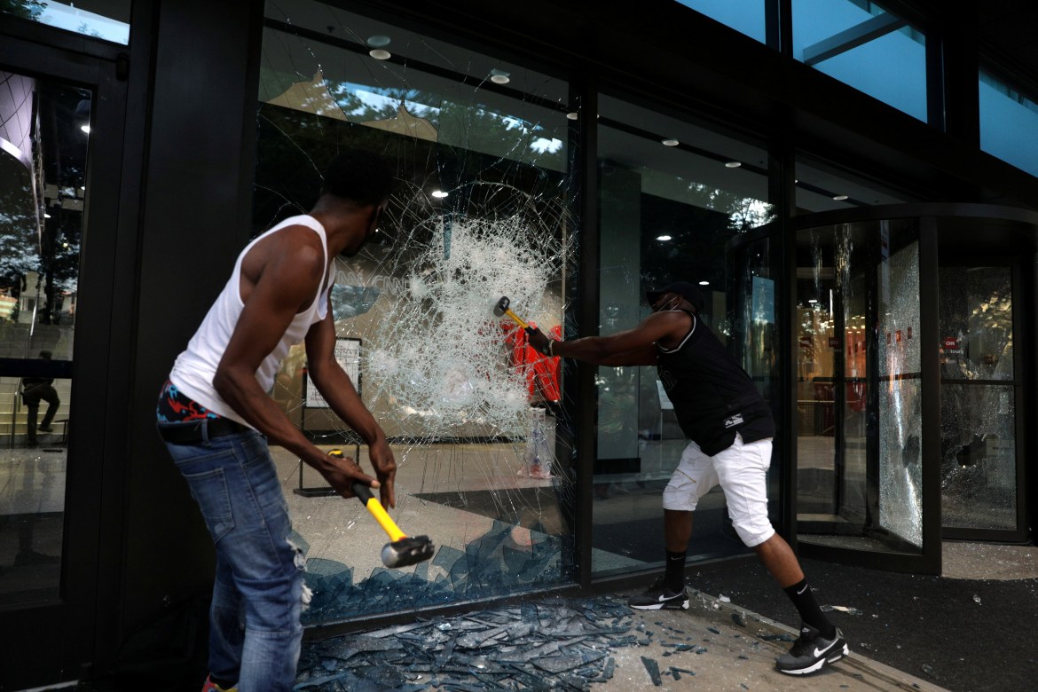 Protesters break a window at the CNN Center during a protest against the death in Minneapolis police custody of African-American man George Floyd, in Atlanta