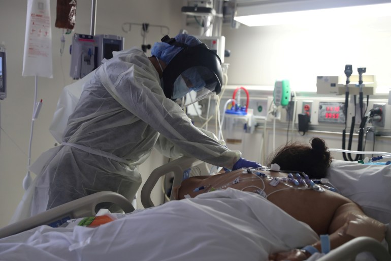 A medical staff member treats a patient suffering from the coronavirus disease (COVID-19) in the Intensive Care Unit (ICU), at Scripps Mercy Hospital in Chula Vista
