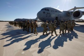 U.S. Army paratroopers of an immediate reaction force from the 82nd Airborne Division leave Fort Bragg