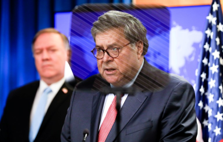 Attorney General William Barr speaks as U.S. Secretary of State Pompeo listens during a joint briefing about International Criminal Court in Washington