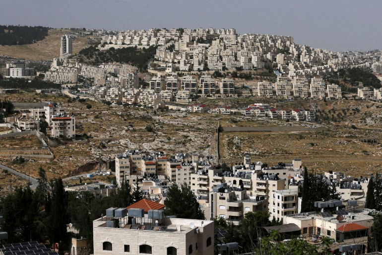 A view shows the Israeli settlement of Har Homa in the background as Palestinian houses are seen in the foreground, in the Israeli-occupied West Bank