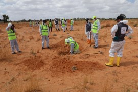 Members of the Government of National Accord's (GNA's) missing persons bureau search for human remains in what Libya's internationally recognized government officials say is a mass grave, in Tarhouna city