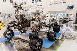 Engineers observe the first driving test for NASA's Perseverance Mars rover in a clean room at Jet Propulsion Laboratory