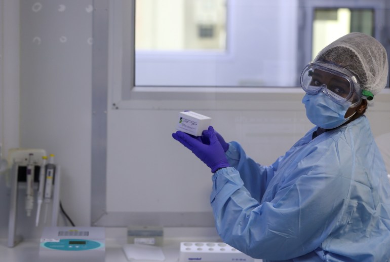 A scientist at CapeBio Technologies works on a test kit at a laboratory in Centurion
