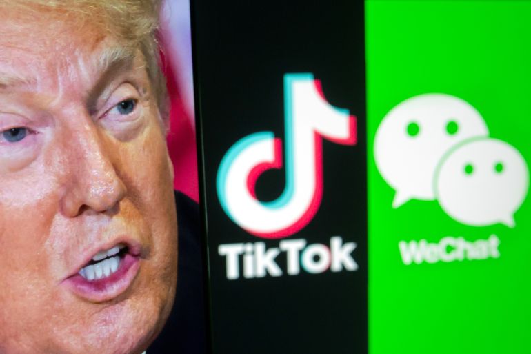 A picture of U.S. President Donald Trump is seen on a smartphone in front of displayed Tik Tok and WeChat logos in this illustration