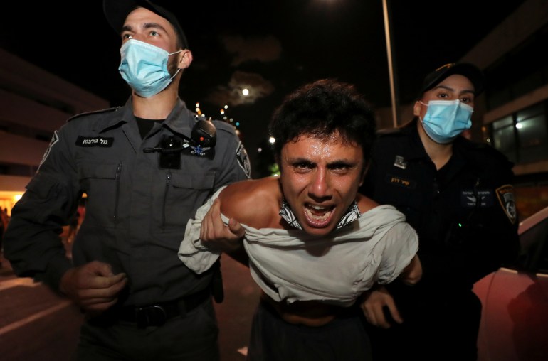 Israelis protest against law that limits protests during the coronavirus disease (COVID-19) lockdown, in Tel Aviv