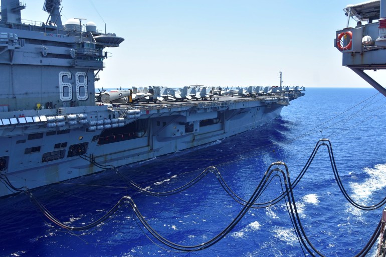 U.S. Navy aircraft carrier USS Nimitz receives fuel from the Henry J. Kaiser-class fleet replenishment oiler USNS Tippecanoe