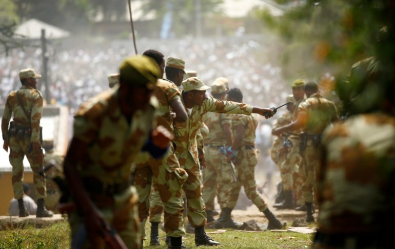Security personnel attempt to stop protesters during the Irrechaa, the thanks giving festival of the Oromo people in Bishoftu town of Oromia region, Ethiopia