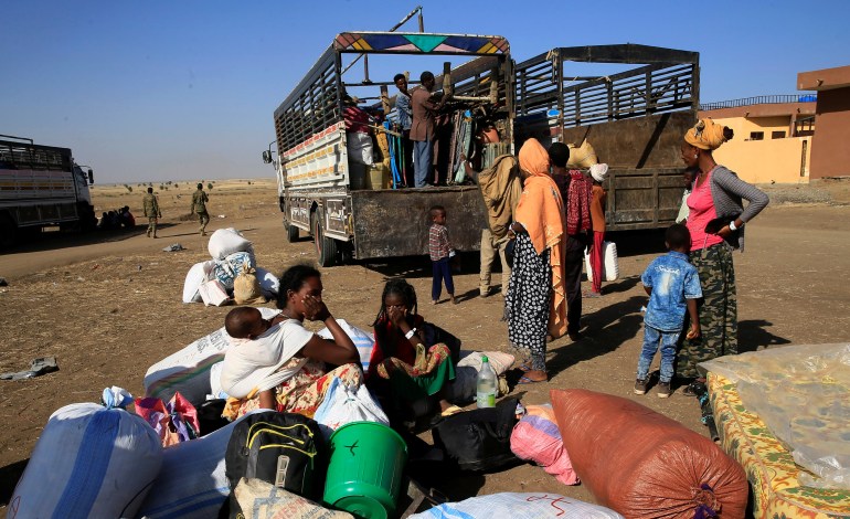 Ethiopians who fled the ongoing fighting in Tigray region, prepare to board a courtesy trucks in Hamdayet village on the Sudan-Ethiopia border, eastern Kassala state